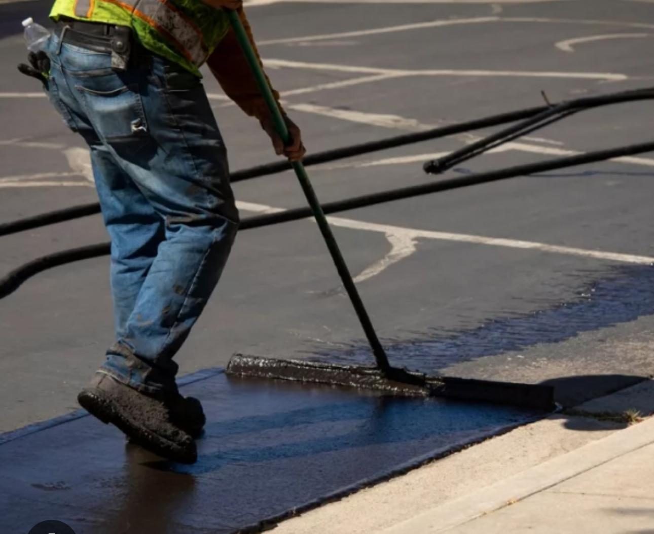 Fresh black asphalt sealcoating finish for driveway or parking lot